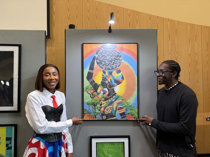 Immanuel Obani with a visitor beside Vessel of Memory at BAFA 2026