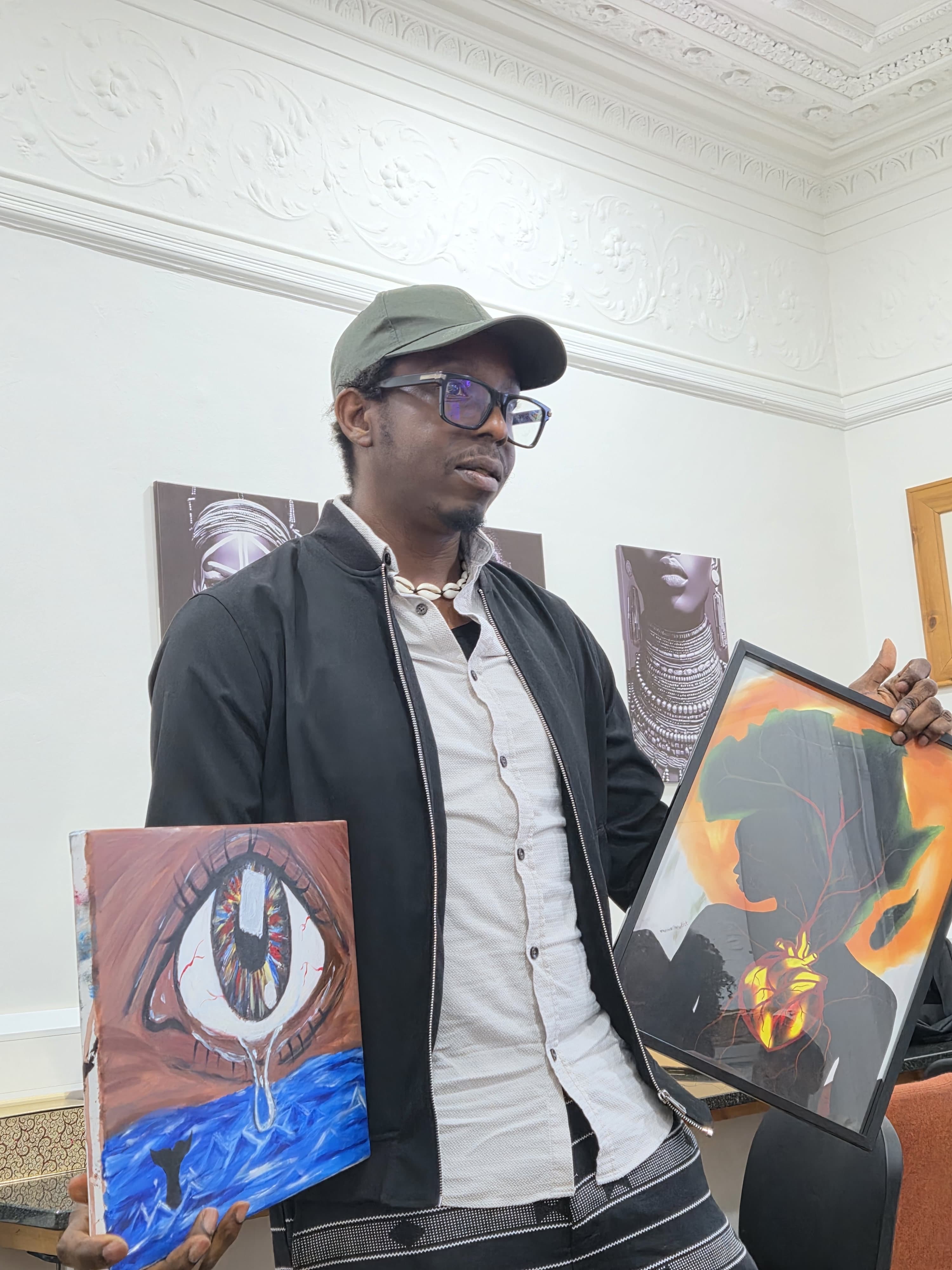Immanuel Obani presenting two original artworks at Paint Converse 2026